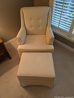 Front view of cream armchair with matching ottoman