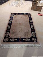 Top view of entire Chinese wool rug showing design, border, fringes
