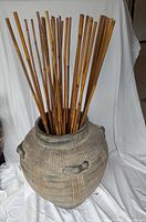 Front view of ceramic vase with bamboo sticks