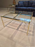 Full view of square brass and glass coffee table