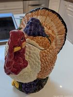 Full view of ceramic turkey cookie jar showing colors, shape, lid seam