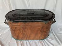 Full view of oval copper boiler with lid and handles