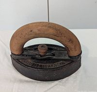 Top view showing cast iron body, wooden handle and embossed lettering