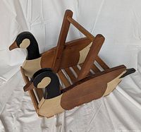 Overall view showing wooden magazine holder with duck side panels and handle
