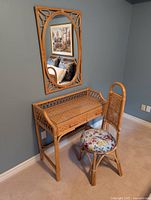 Vanity table, chair and mirror arranged against wall