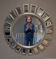 Front view of light gold sunburst wall mirror displaying design and condition