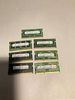 Seven Samsung 2GB laptop SO-DIMM modules laid out face up