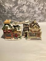 Both ceramic village buildings side by side with cords visible