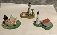 All three Danbury Mint lighthouse miniatures overview