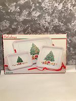 Box showing image of the three HIMARK holiday trays