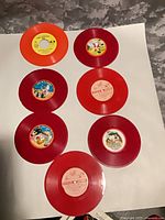 All seven colored-vinyl 45 RPM records displayed on white background