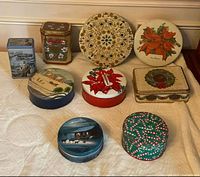 Group shot of nine tins displaying shapes, sizes and designs