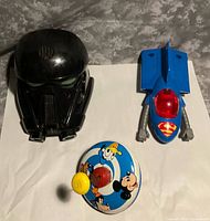 All three items laid out: helmet, Supermobile, tin top