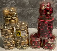 All nine tubs of ornaments displayed together, showing gold and red color assortment