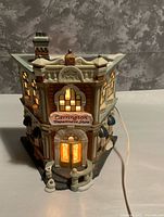 Front and side view of illuminated Carrington Department Store building with cord visible