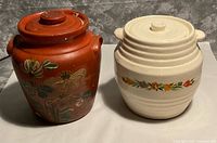 Front view of both ceramic jars with lids