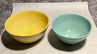 Yellow and blue-green Pfaltzgraff ceramic bowls side by side
