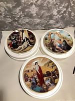 All three ArtAffects plates on display bases showing front artwork