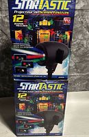 Two boxed StarTastic Motion projectors stacked vertically