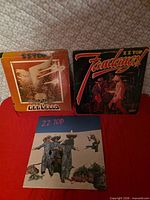 Front jackets of Degüello and Fandango! beside each other on red surface