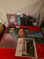 Seven of eight LP jackets displayed; top row standing, bottom row overlapping