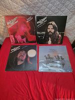 All four Bob Seger LP albums laid out on red surface