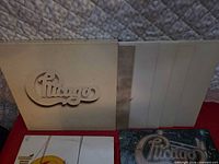 Box set with die-cut logo and multiple white LP sleeves visible