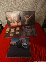 Five ELP album covers arranged on red surface