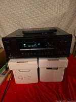 Front view of Onkyo TX-DS595 receiver with remote on top