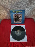 Record on white inner sleeve with cover behind