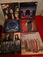 All six album covers displayed on red surface