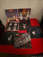All seven KISS albums arranged showing cover art