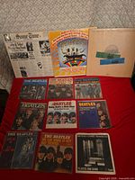 Group shot of entire lot showing three LPs and multiple Beatles 45 rpm singles