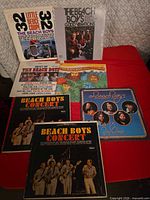 All six Beach Boys LPs laid out on red surface