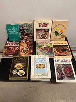 Front view of all eleven cookbooks arranged on table