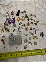 All jewelry pieces laid out for overview with measuring tape