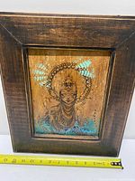 Framed mixed media artwork with measuring tape showing width about 11 inches