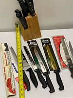 Full view of knife block and loose knives with measuring tape for scale