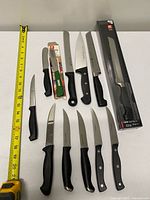 Full layout of all twelve knives with measuring tape
