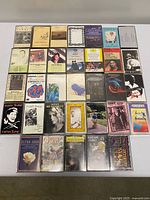 Top-down view of all 32 cassette tapes arranged in 4×8 grid