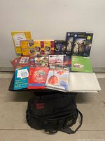 All items spread on small table showing variety of photo paper packs and shoulder bag