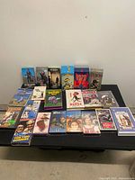 Overall shot of all 21 VHS tapes and box sets on table