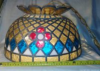 Full view of leaded glass pendant lamp with measuring tape showing diameter