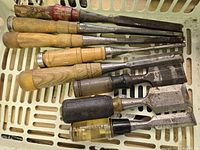 All eight chisels in basket, handles at left, blades at right