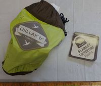 Hammock packed in attached pouch showing Chillax La Siesta branding and ruler for scale