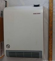 Front view of white Stiebel Eltron CK 150-1 Trend heater with vent, dial and logo visible