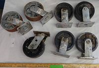 All seven caster wheels laid out showing varying sizes and condition