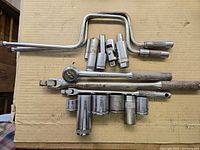 Full assortment of Husky sockets, ratchet, extensions, speed handle and universals laid out on cardboard