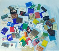 spread of assorted matchbooks and matchboxes on white background