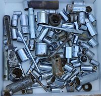 Top-down view of assorted sockets, ratchet, extensions in box